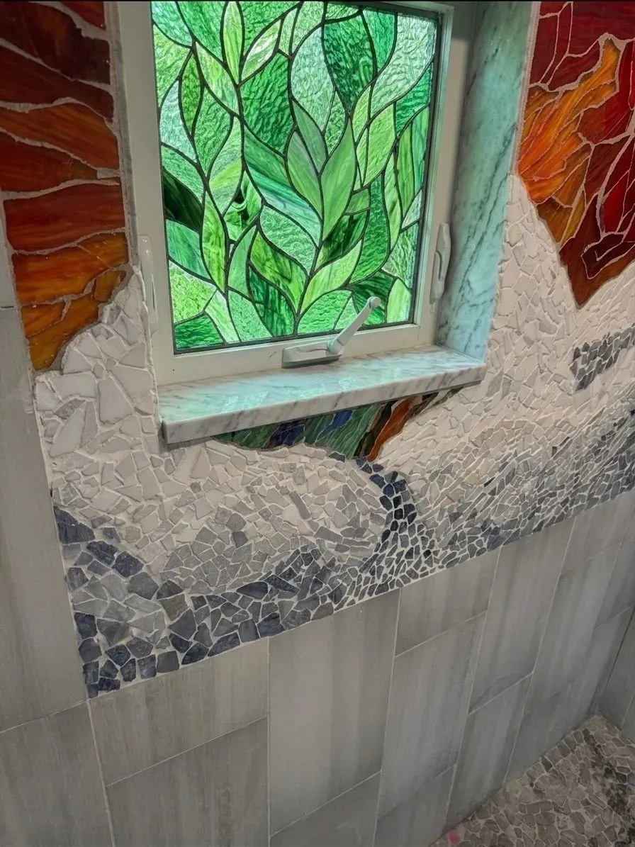 Hand-cut Colorado mountain landscape mosaic framing a stained-glass window